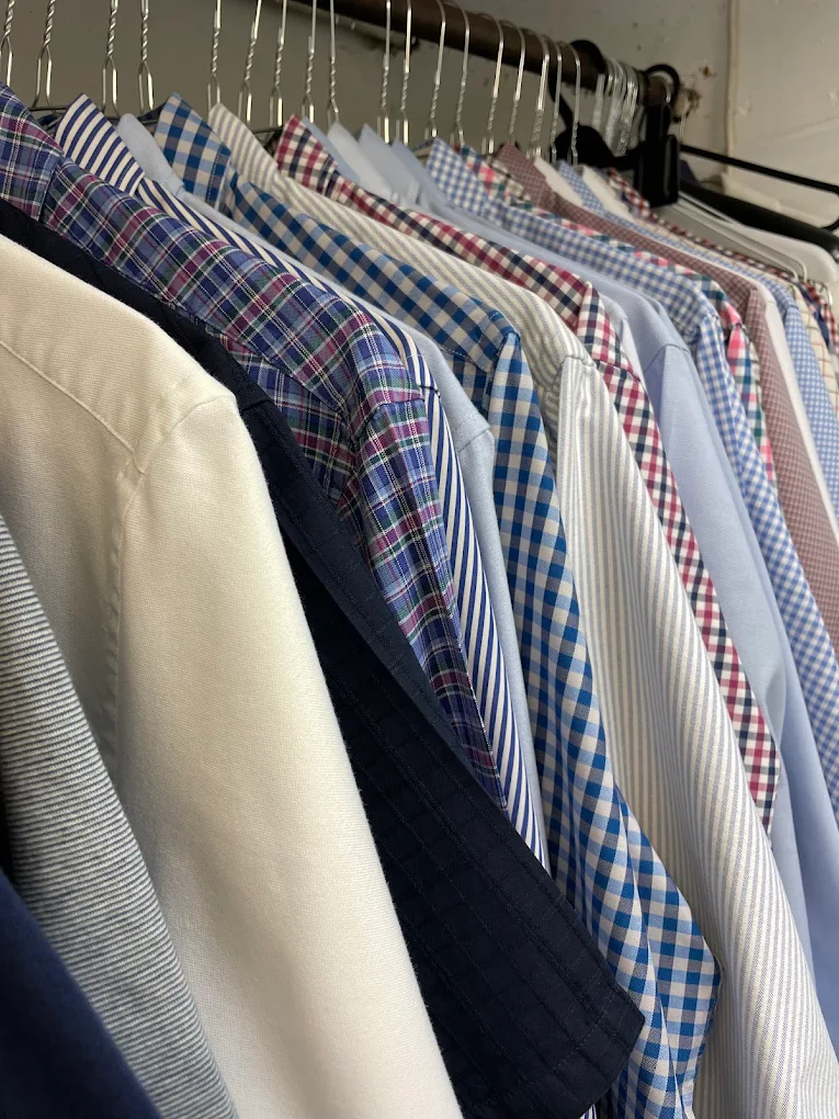 Freshly cleaned shirts hanging at Perfecta Cleaners